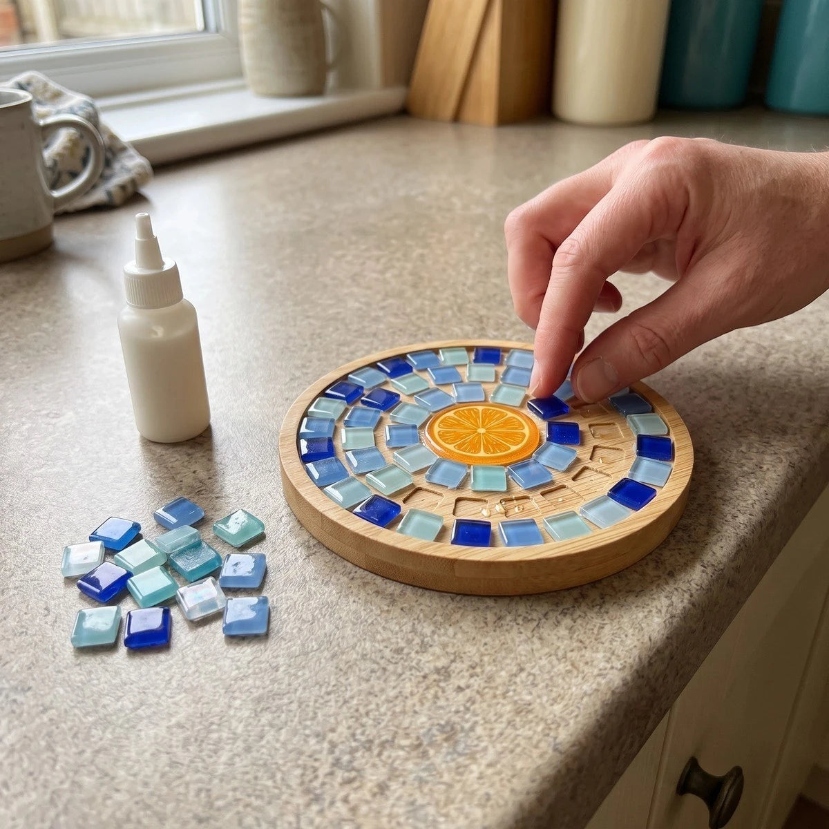 Finished mosaic coaster beside a cup on a living-room table